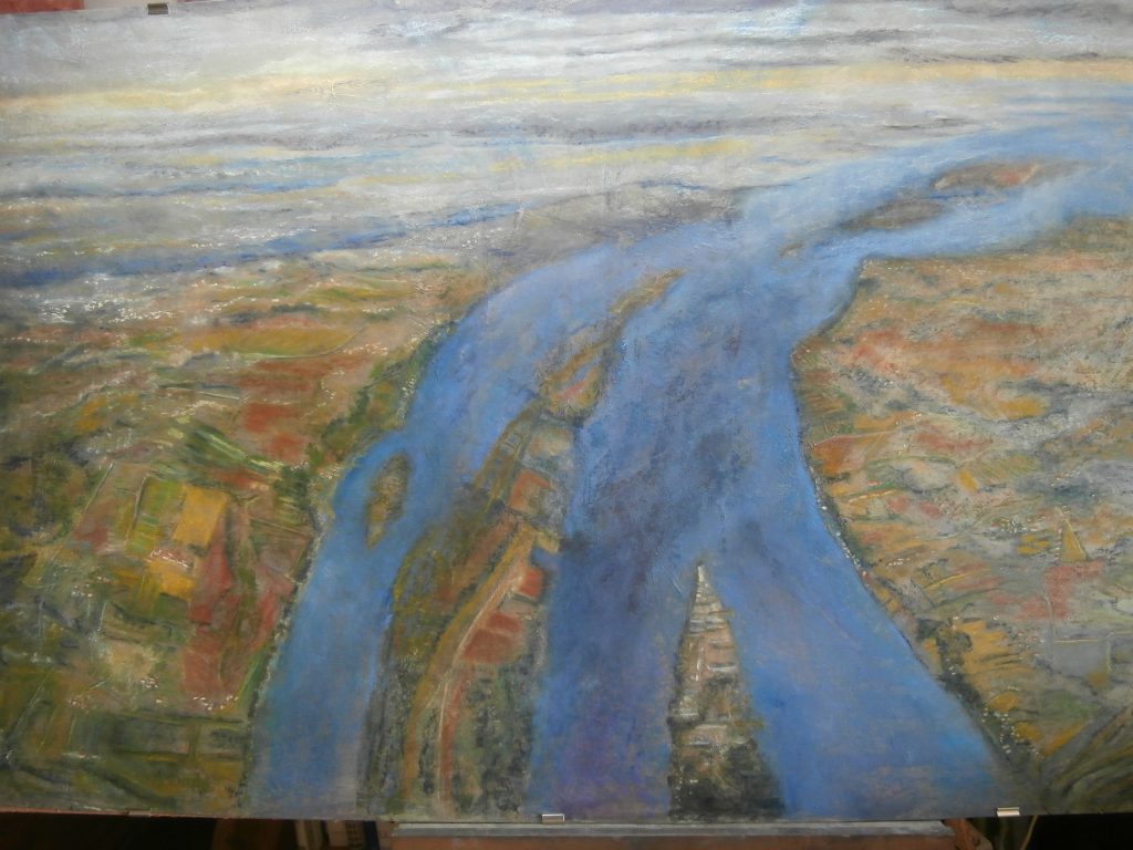 vue de hauteur de l'estuaire de la gironde, l'eau est de divers bleus, les champs sont bariolés. Art contemporain